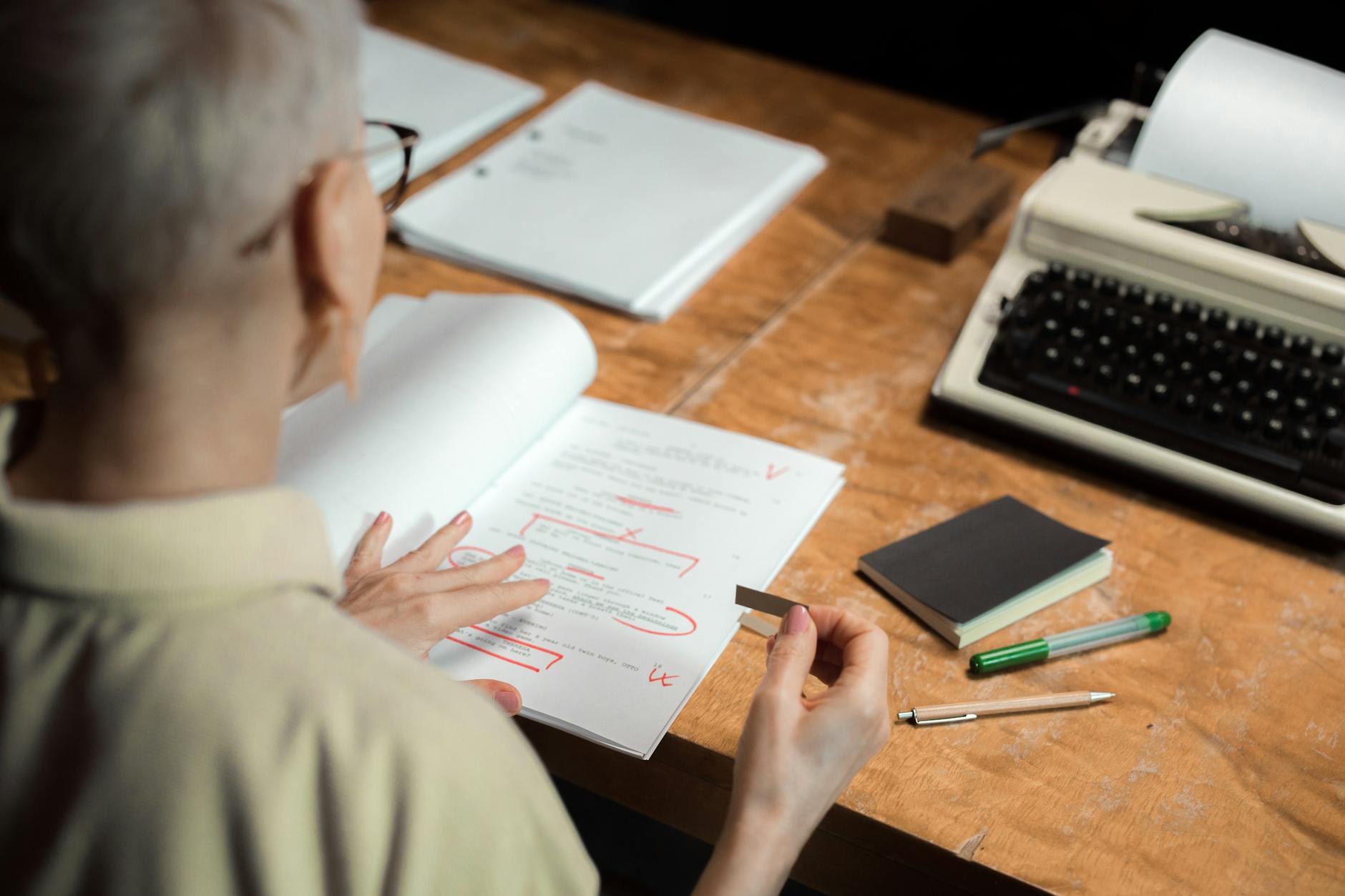 Escritora revisando el manuscrito de su novela con atención