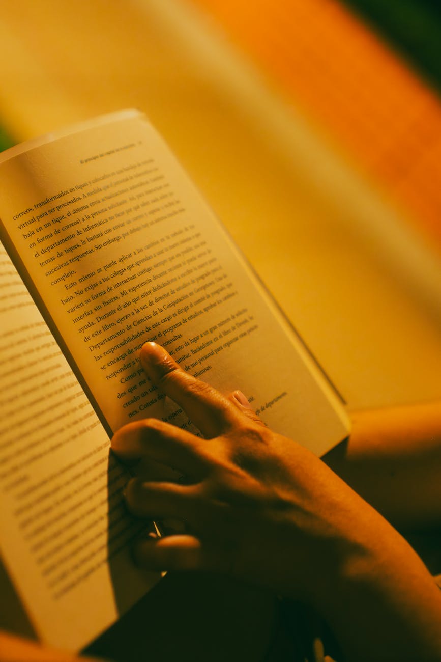 warm light on hands holding an open book